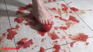 Several tomatoes are crushed under my wonderful bare feet