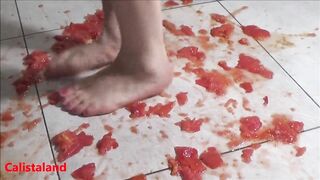 Several tomatoes are crushed under my wonderful bare feet
