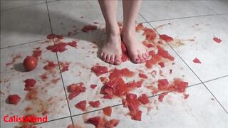 Several tomatoes are crushed under my wonderful bare feet