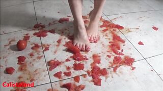 Several tomatoes are crushed under my wonderful bare feet