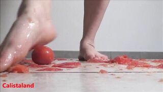 Several tomatoes are crushed under my wonderful bare feet