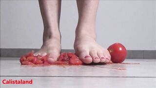 Several tomatoes are crushed under my wonderful bare feet