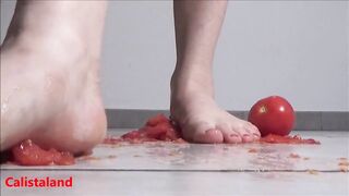 Several tomatoes are crushed under my wonderful bare feet