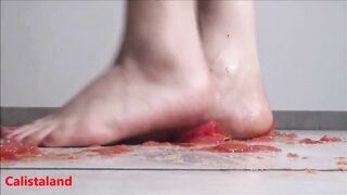 Several tomatoes are crushed under my wonderful bare feet
