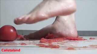 Several tomatoes are crushed under my wonderful bare feet