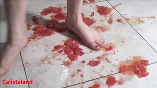 Several tomatoes are crushed under my wonderful bare feet