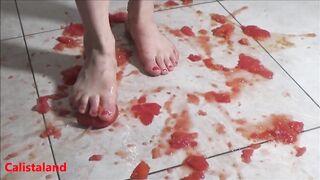 Several tomatoes are crushed under my wonderful bare feet