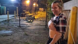 Girl walks down street topless