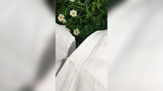 Girl watering Wild Flowers with her Pee on the Roadside