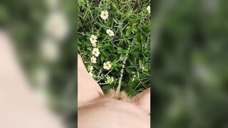 Girl watering Wild Flowers with her Pee on the Roadside