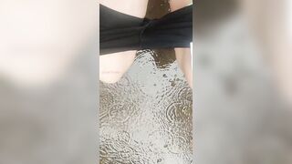 Girl Peed desperately in the rain to the puddle