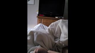 Laying in bed playing with his cock