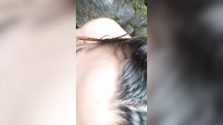 Sexy Latin girl in sunglasses sucking by crowded waterfall