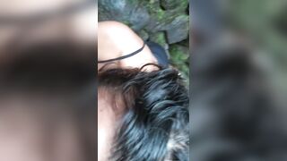 Sexy Latin girl in sunglasses sucking by crowded waterfall