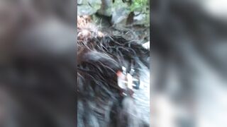 Sexy Latin girl in sunglasses sucking by crowded waterfall